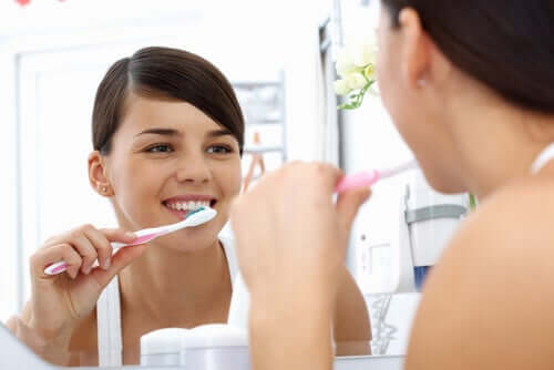 Woman brushing teeth.