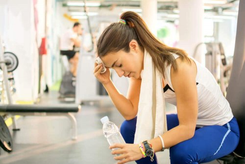 Woman resting from exercise in the gym.