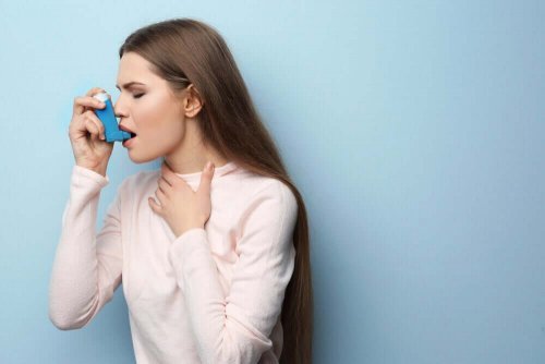 Woman using inhaler.