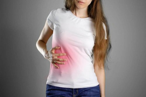 Woman with a liver problem holding her side.