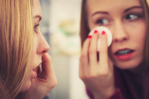 A woman removing her makeup.