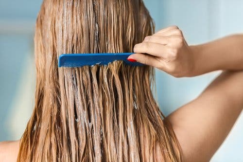 A person combing their hair.
