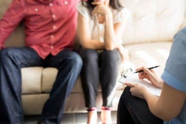 Two people talking to a therapist.