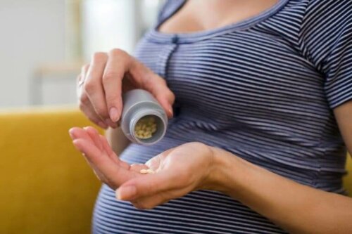 Pregnant woman taking pills.