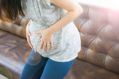 A woman holding her belly.