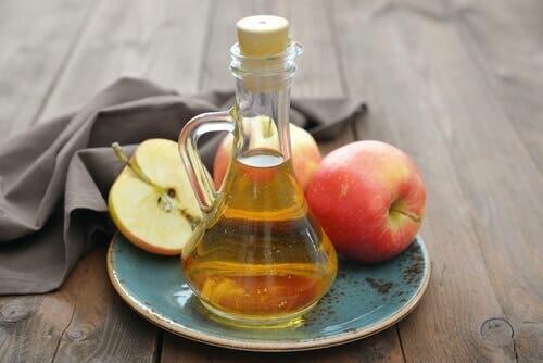 Apple cider vinegar in a glass container, useful to regulate your period.