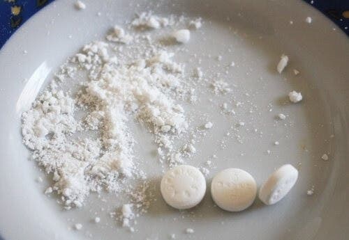 Aspirin ground up on a plate for cleaning rusty jewelry.