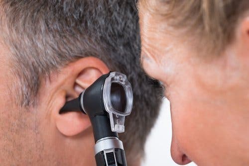 A doctor looking at their patient's ear.