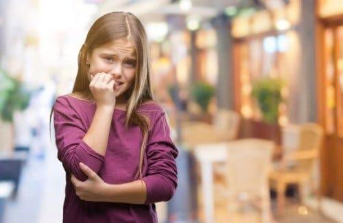 A nervous girl biting her nails.