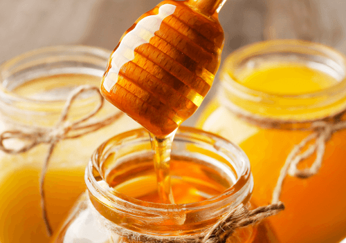 Honey jars with honey dipper.