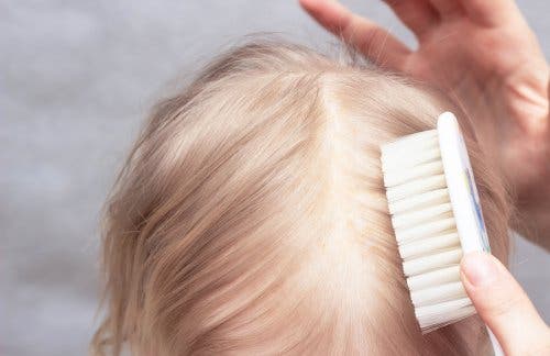 Brushing a child's hair for cradle cap.
