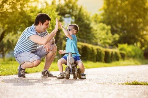 A dad giving his son a high-five to teach resilience and hope