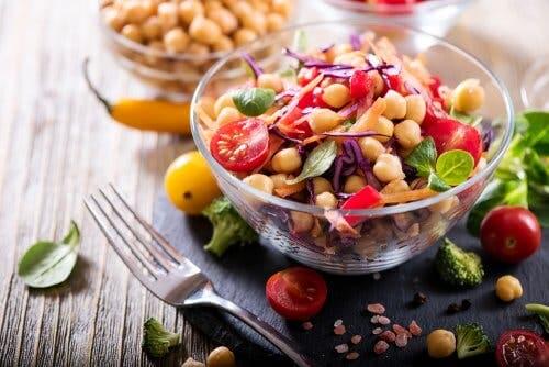 Chickpea and eggplant salad in a clear bowl.