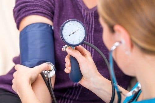 A doctor taking a patient's blood pressure.