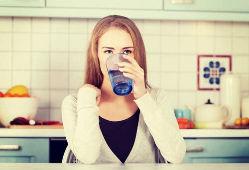 A woman drinking water.