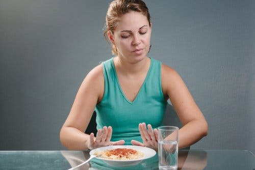 Woman on satiating diet refusing food.