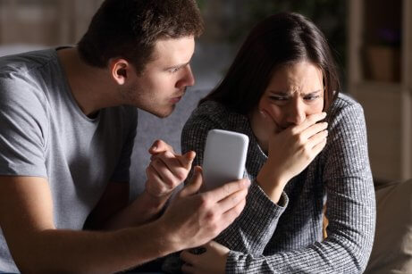 A man going through his girlfriend's phone.