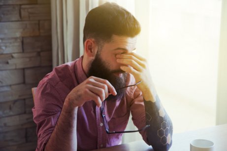 A man rubbing his eyes.