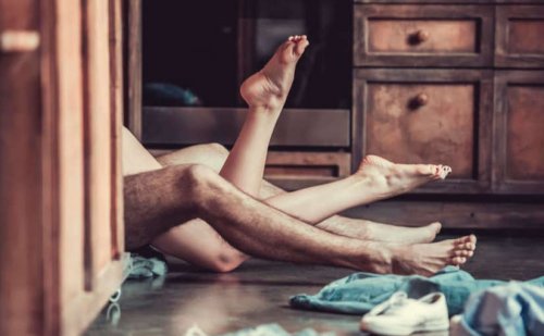 A couple having sex on the floor.