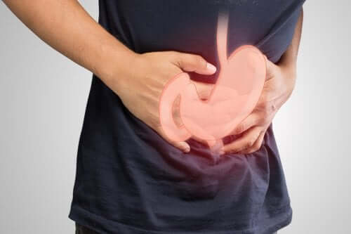 Man holding stomach in pain due to duodenal ulcers.