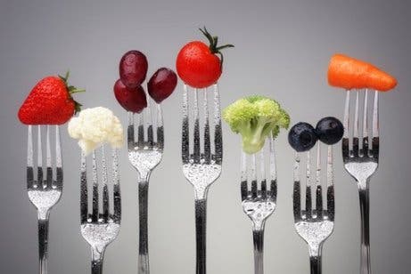 Healthy fruits and vegetables on the ends of forks.