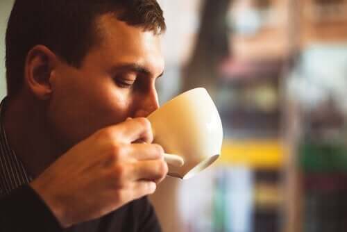 A man drinking a cup of coffee.