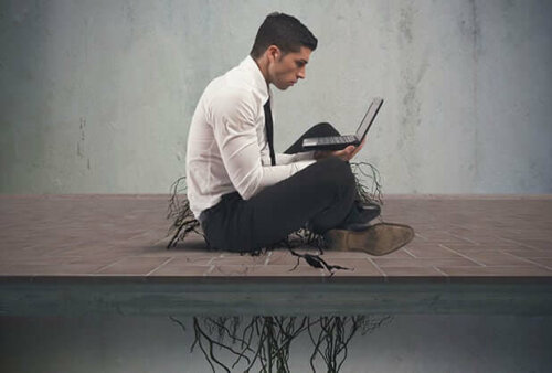 Man on laptop with roots keeping him on the ground, porn addiction.
