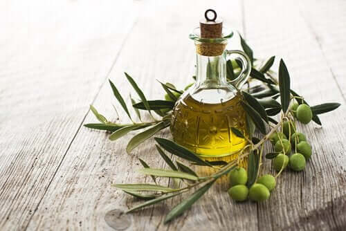 Olive oil in a jar next to olives, an essential part of the Mediterranean diet.