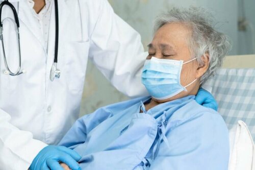 A patient and doctor wearing protective equipment.
