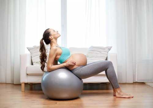 A pregnant woman with an exercise ball.