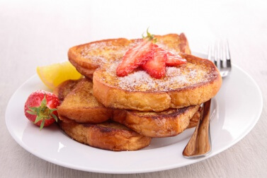 Vegan french toast with strawberries on top.