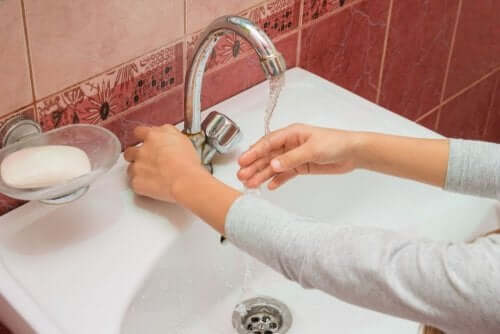 Washing hand in sink.