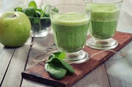 A couple apple and spinach smoothies.