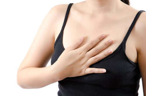 A woman touching her chest.