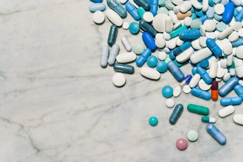 A pile of pills on a marble surface.