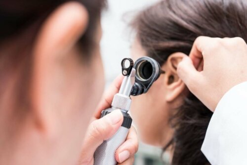 A doctor evaluating a person's ear.