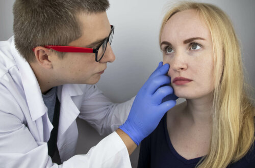 A doctor looking at a woman's eyes.