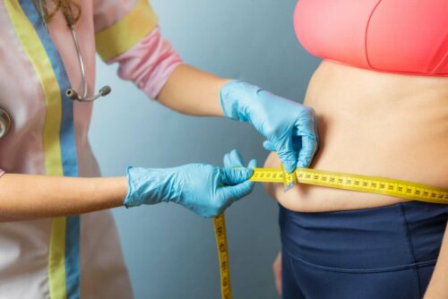 A doctor measuring an overweight person.