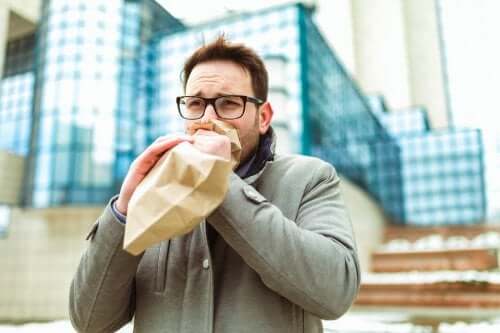 A person blowing up a paper bag.