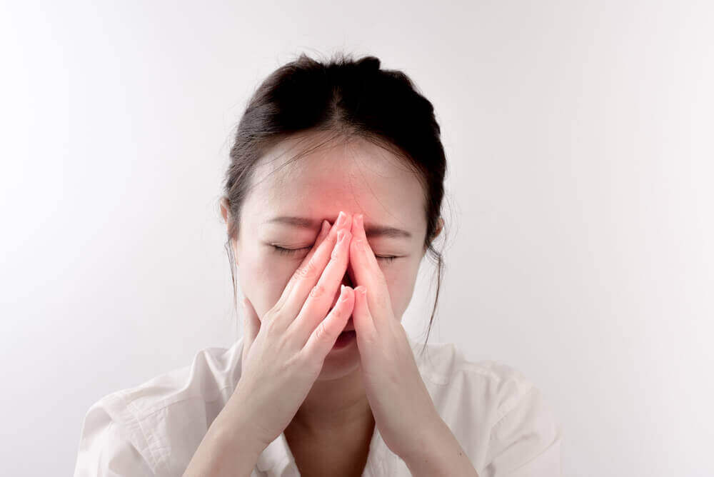 A woman experiencing a headache.