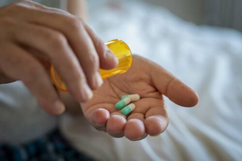 A person taking antibiotics.