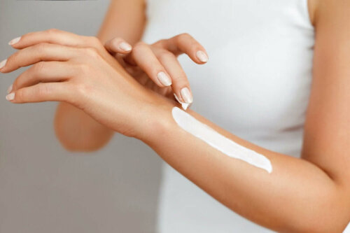 A woman applying sunscreen.