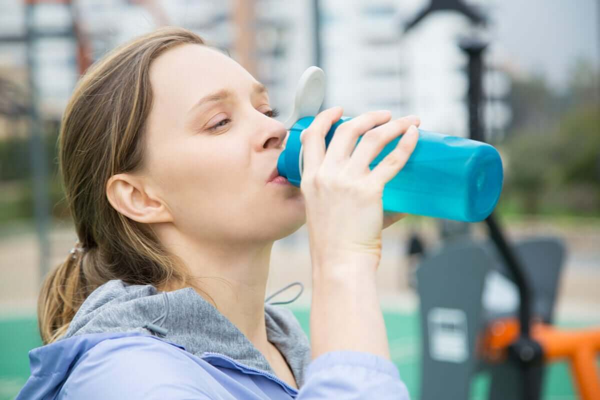 A woman drinking water.