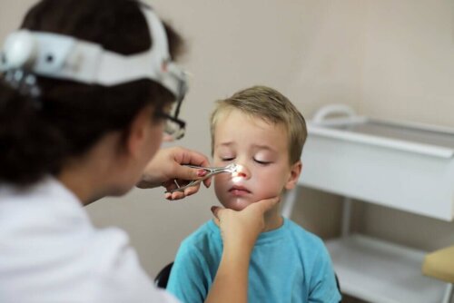 A doctor looking into a child's nose.