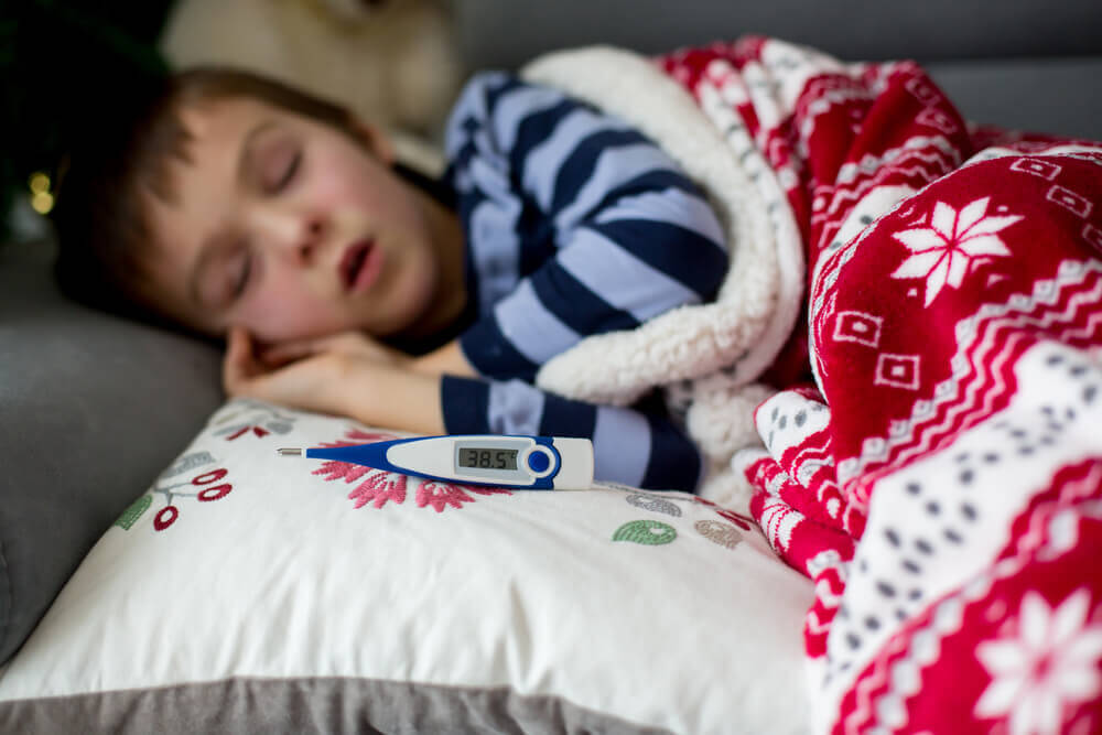 A child in bed with a fever.