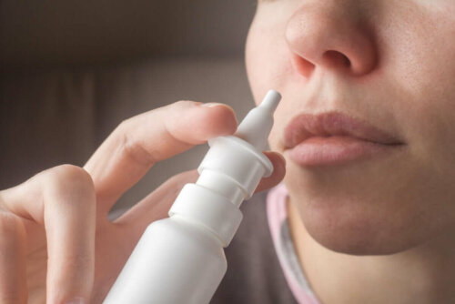 A woman using a saline solution nasal spray.