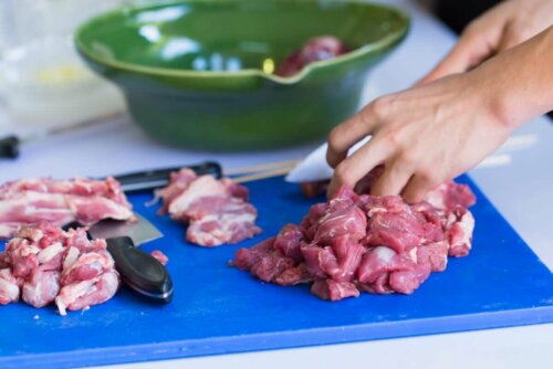 A person cutting meat.