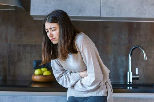 A woman suffering from a stomachache due to a ginger allergy.