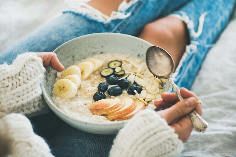 A woman eating oats for breakfast.