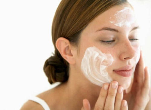 A woman washing her face.